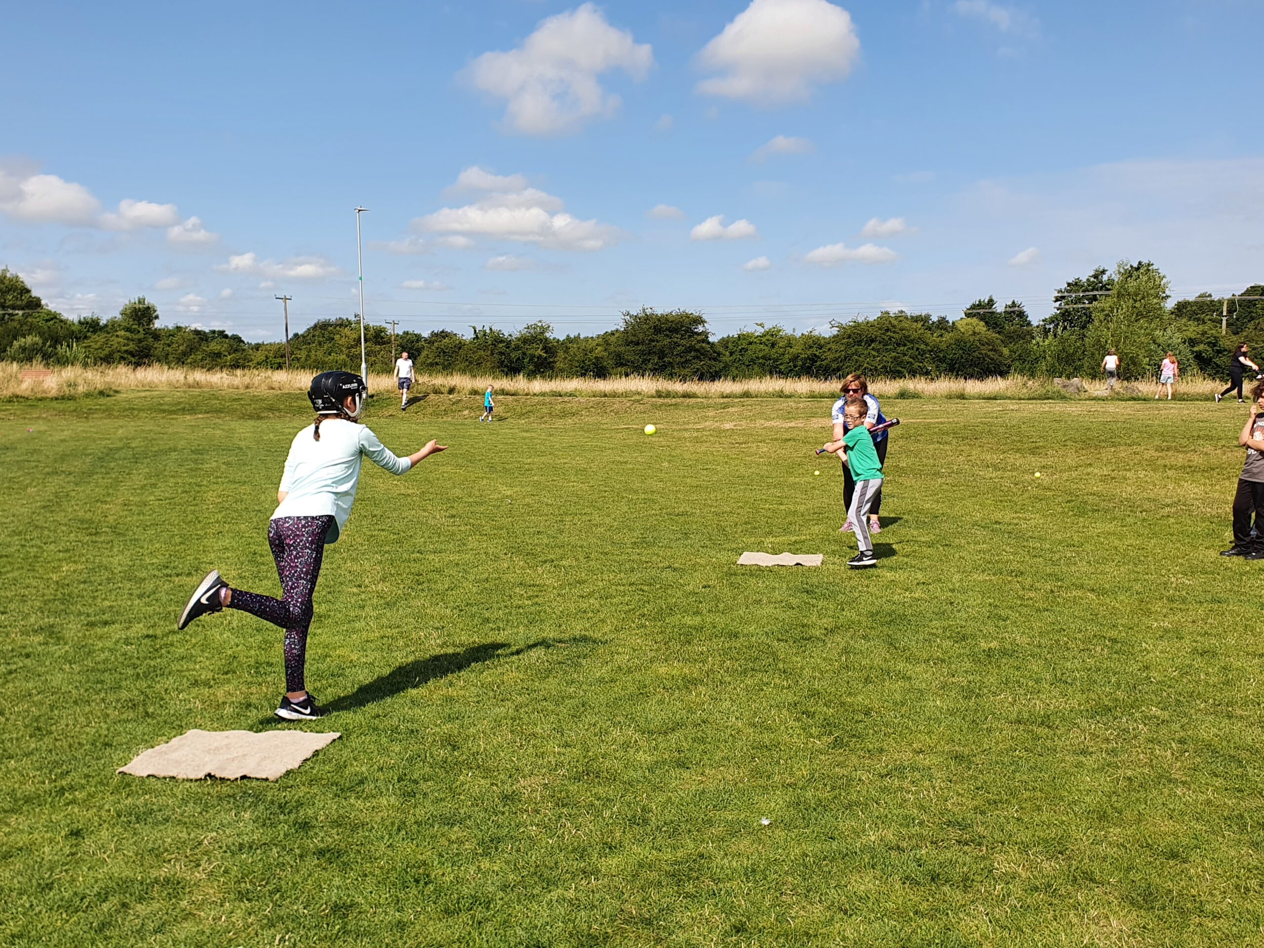 Children playing rounders in a park