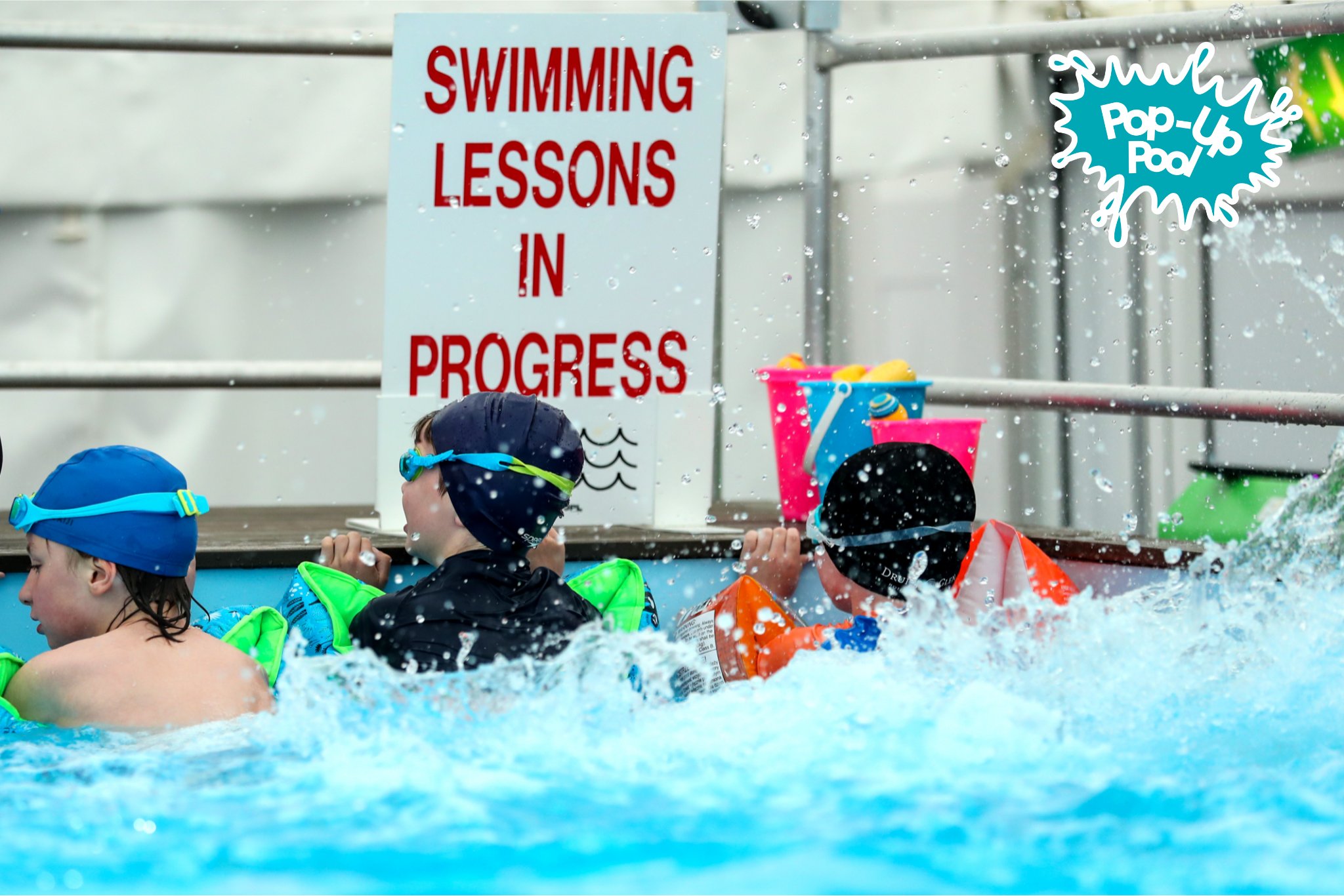 Kids learning to swim in pop up pool