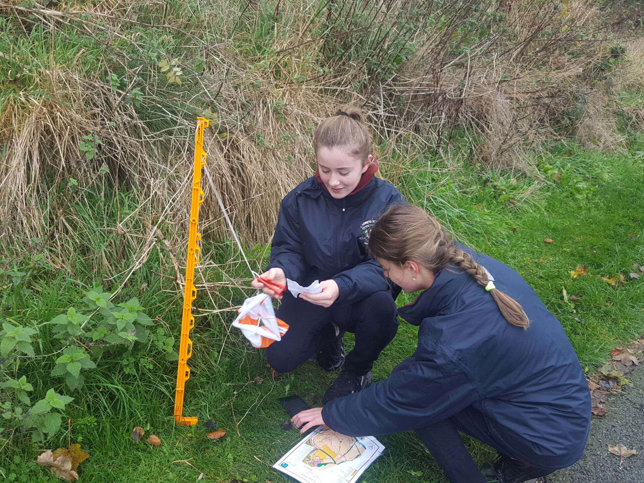 Two girls reading an orienteering map