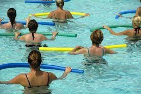 Women holding floats in water