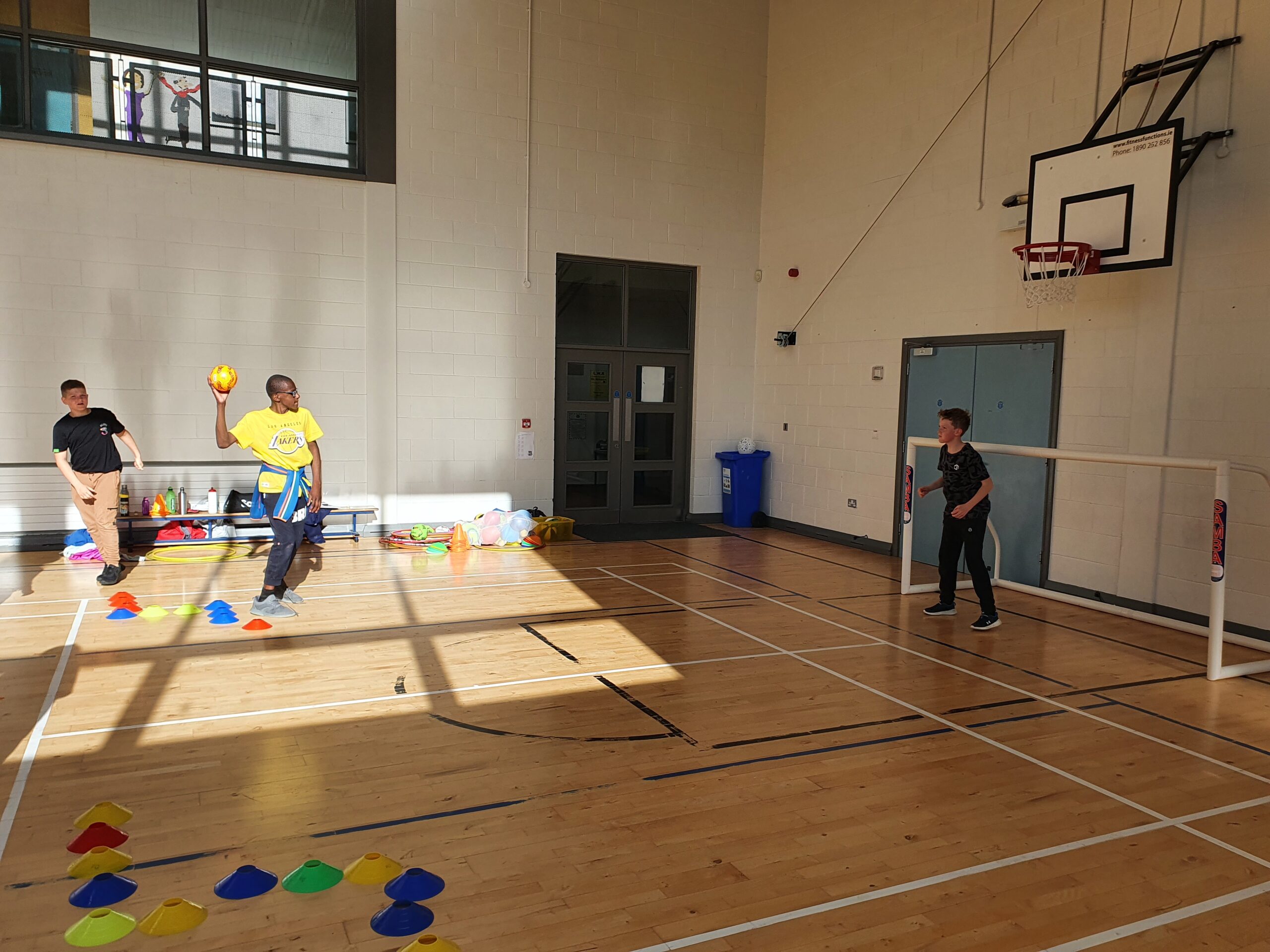 Kids throwing a ball in a hall