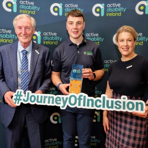 3 people holding an award