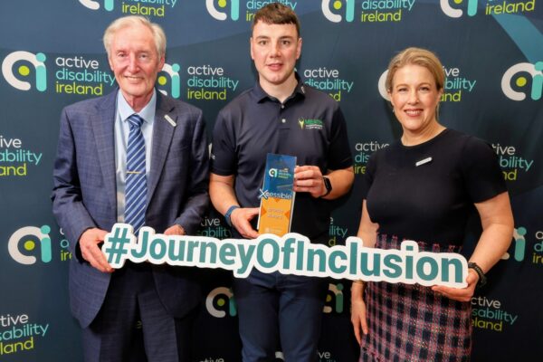3 people holding an award
