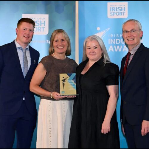 Programme Manager Ruairi Murphy, Sports Development Officer Lisa O'Dowd and chairperson of Meath LSP Board Des Foley accepting the award on stage
