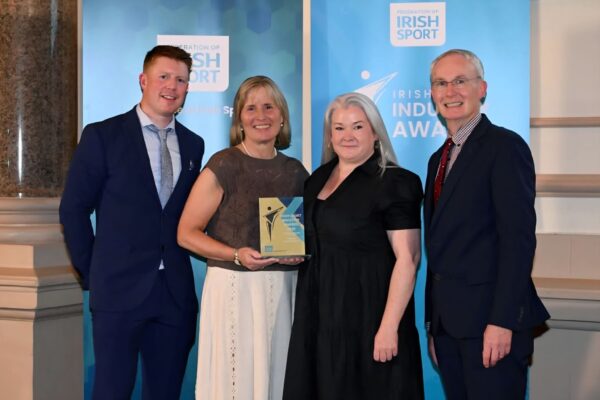 Programme Manager Ruairi Murphy, Sports Development Officer Lisa O'Dowd and chairperson of Meath LSP Board Des Foley accepting the award on stage
